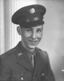 Studio portrait of Harold N. Rhodes in Army Air Forces service dress and peaked cap.
